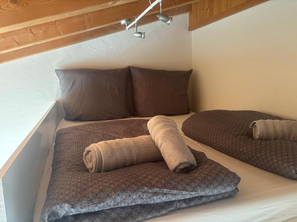 a bed in a room with two pillows on it at Steffis Appartement in Wiesbaden