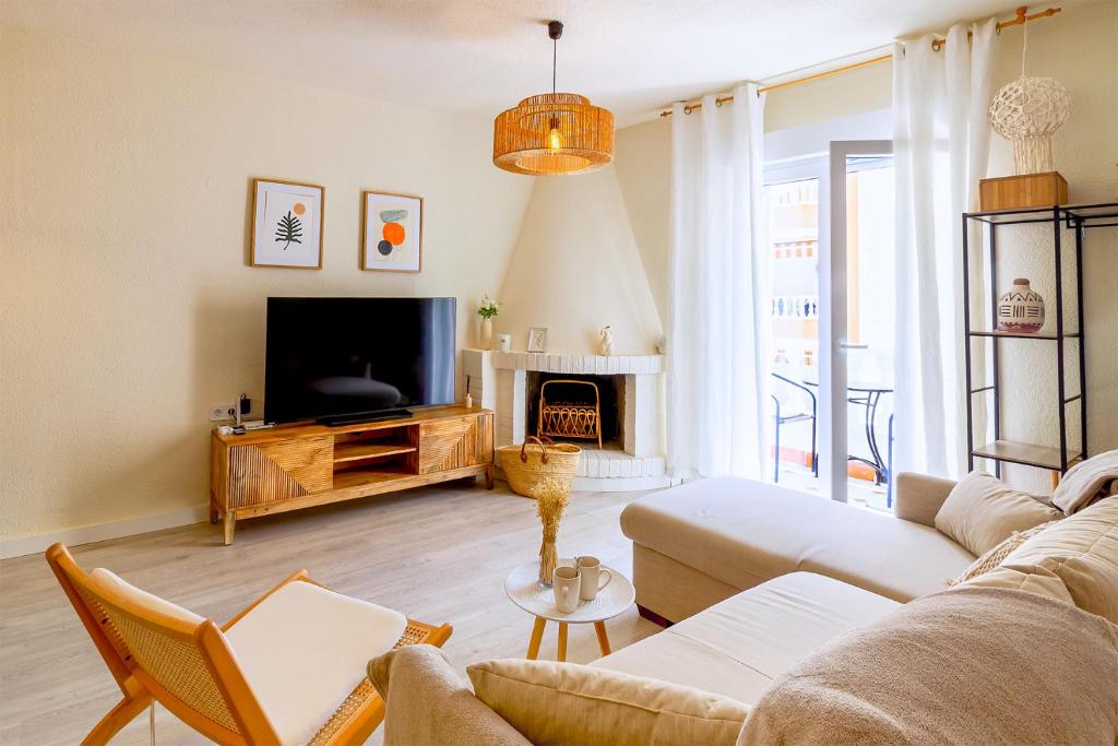 a living room with a couch and a tv at Espanatour SANTA ROSARIA in La Mata