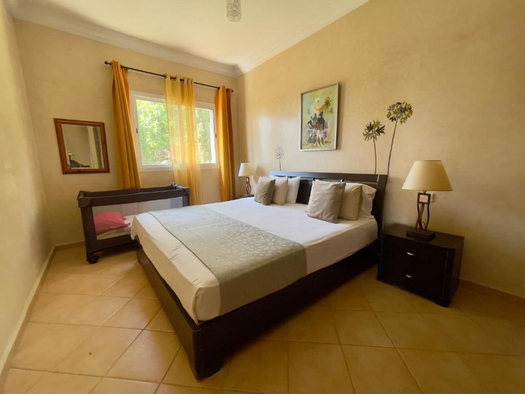 a bedroom with a large bed and a window at A7 Maison Blanche Imi ouaddar in Agadir