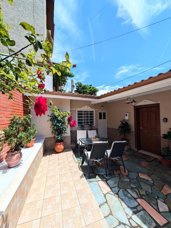 a patio with chairs and a table on a house at Under Castle Walls cottage in Thessaloniki