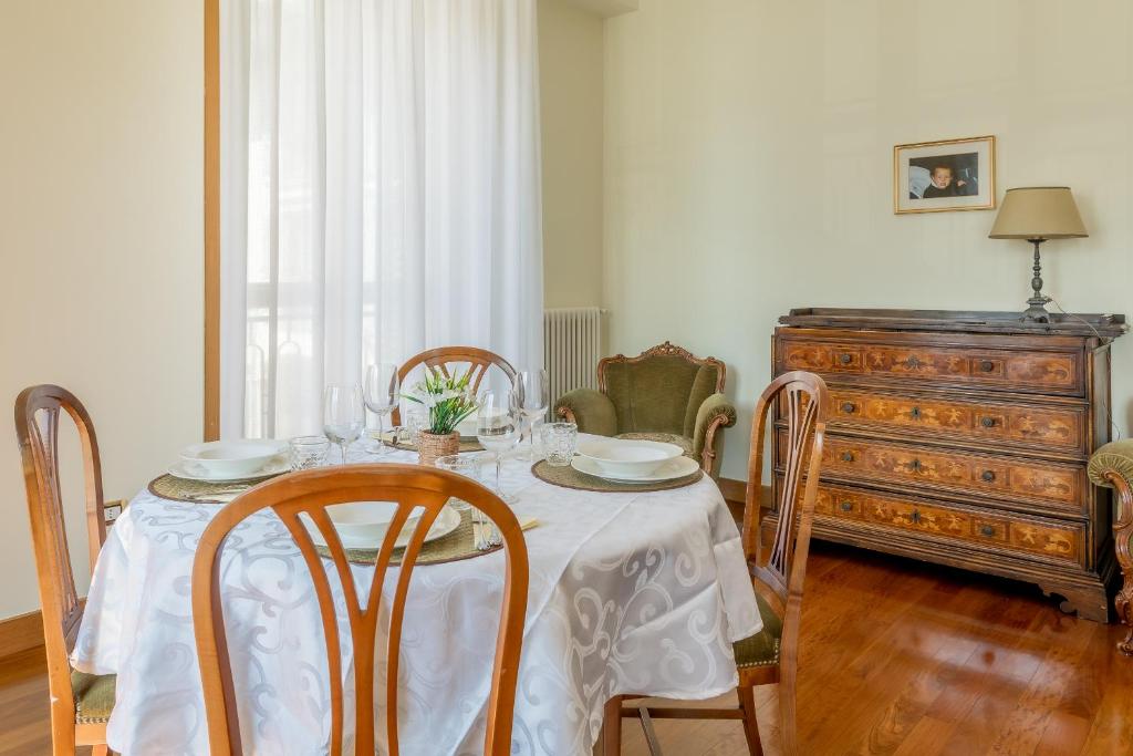 a dining room with a table and chairs and a dresser at Casa MAMMA in Lovere