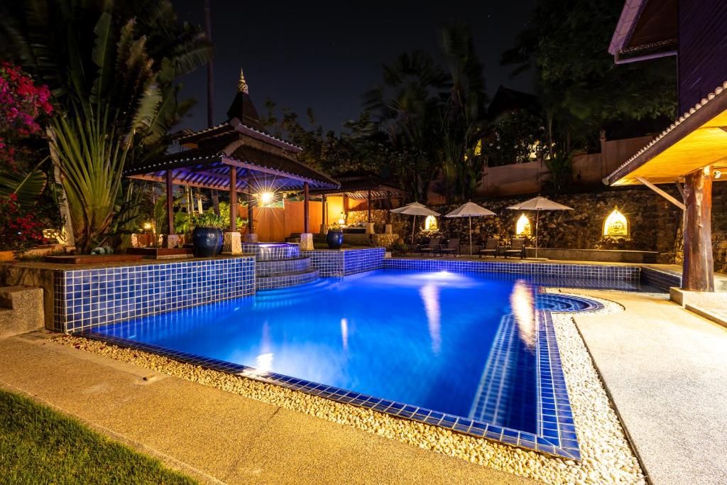 a swimming pool at night with a gazebo at Luxury Villa Miramar Orchid House Samui in Amphoe Koh Samui