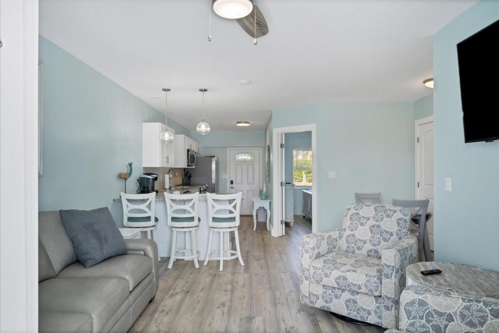 a living room and kitchen with a couch and chairs at 1 BR, Heated POOL, 1 Mile direct gulf access, GREAT Location, Dockage Apt B in Englewood