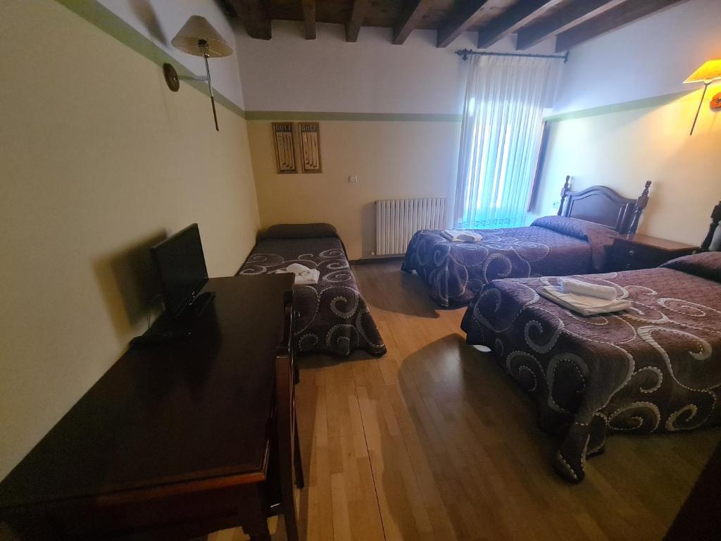 Postel nebo postele na pokoji v ubytování Hostal Las Nieves