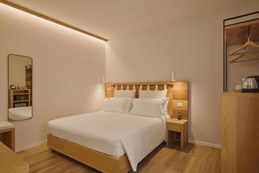 Een bed of bedden in een kamer bij Hotel Le Mura