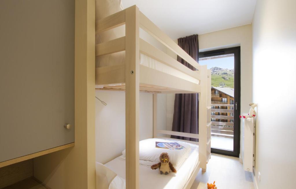 Кровать или кровати в номере Appart'Hôtel Prestige Odalys L'Eclose