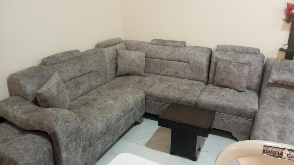 a large brown couch in a living room at Reservacion Sandrita in Ballenita
