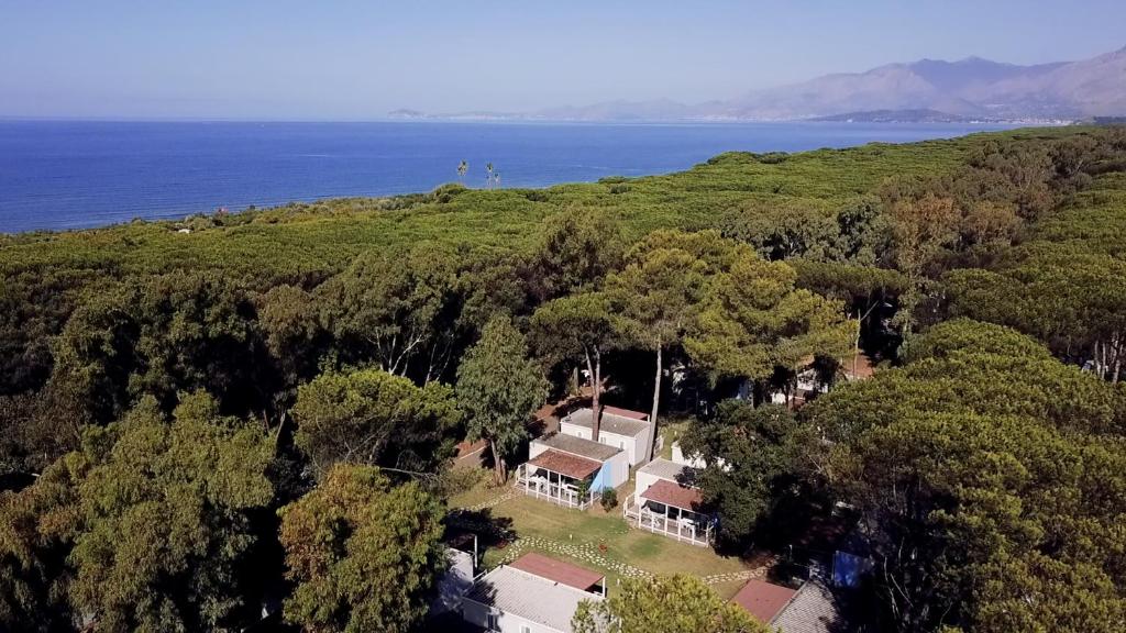 una vista aérea de una casa en una colina junto al océano en Höffmann Bungalowpark Baia Domizia - Village Baia Domizia, en Baia Domizia