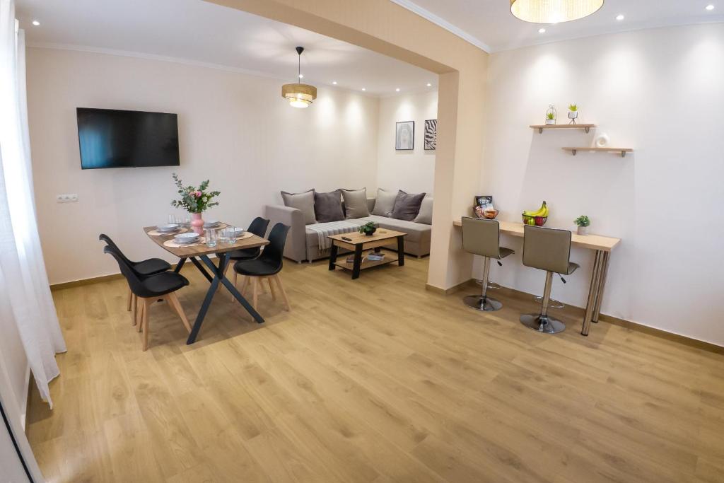 a living room with a table and a couch at Mastiha Luxury Suites in Chios