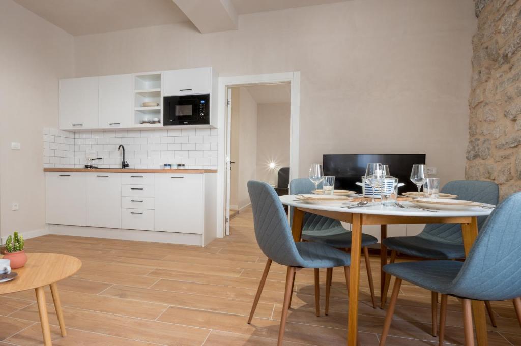 a kitchen and dining room with a table and chairs at Modern Design Old Town Apartment by MN Property in Kotor