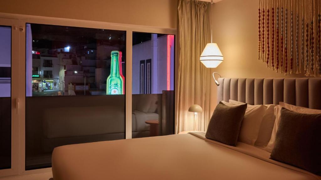 a bedroom with a bed with a large television at Hotel Indigo Albufeira by IHG in Albufeira
