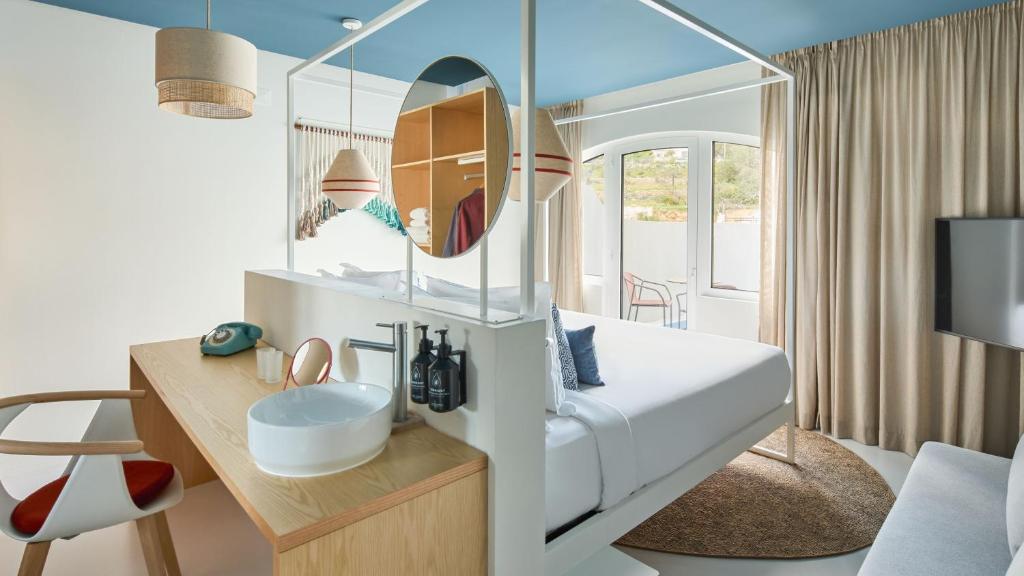 a bathroom with a sink and a mirror at Hotel Indigo Albufeira by IHG in Albufeira