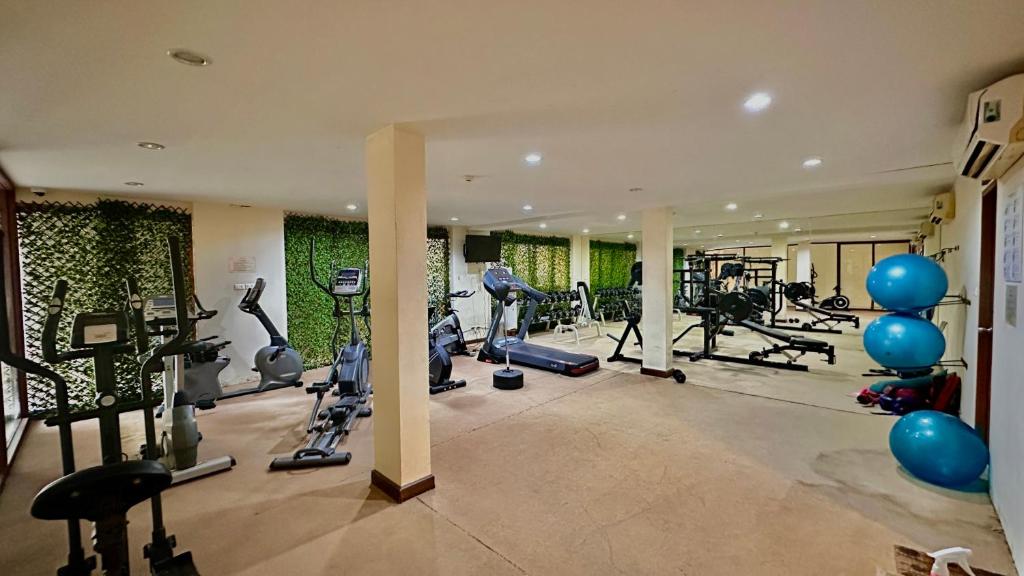 a gym with lots of treadmills and exercise bikes at Deva Beach Resort Samui in Choeng Mon Beach