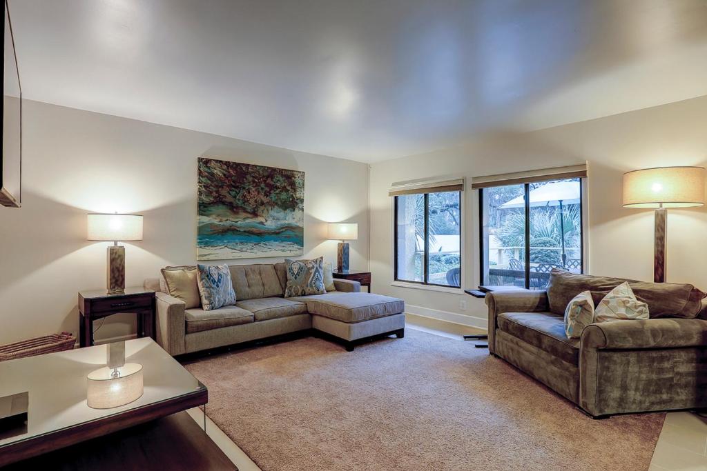 a living room with two couches and a window at Clipper Court 814 in Hilton Head Island