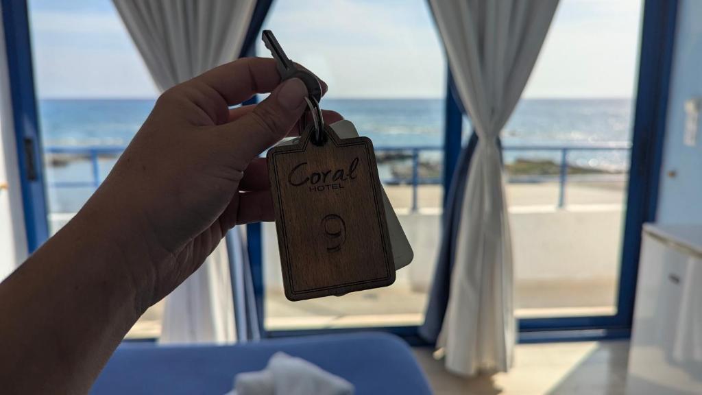 a person holding a price tag in front of a window at Coral in Frangokastello