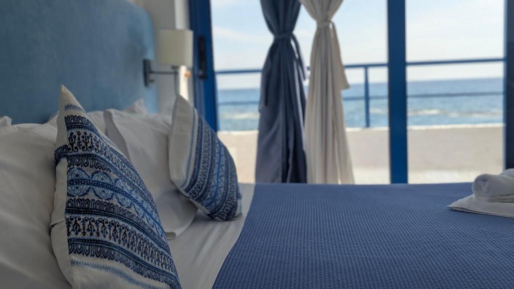 a bedroom with a bed with a view of the beach at Coral in Frangokastello