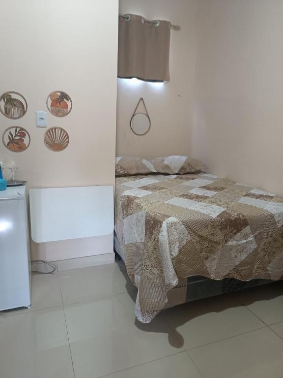 a bedroom with a bed in a white room at Suite das Mangueiras I in Soure