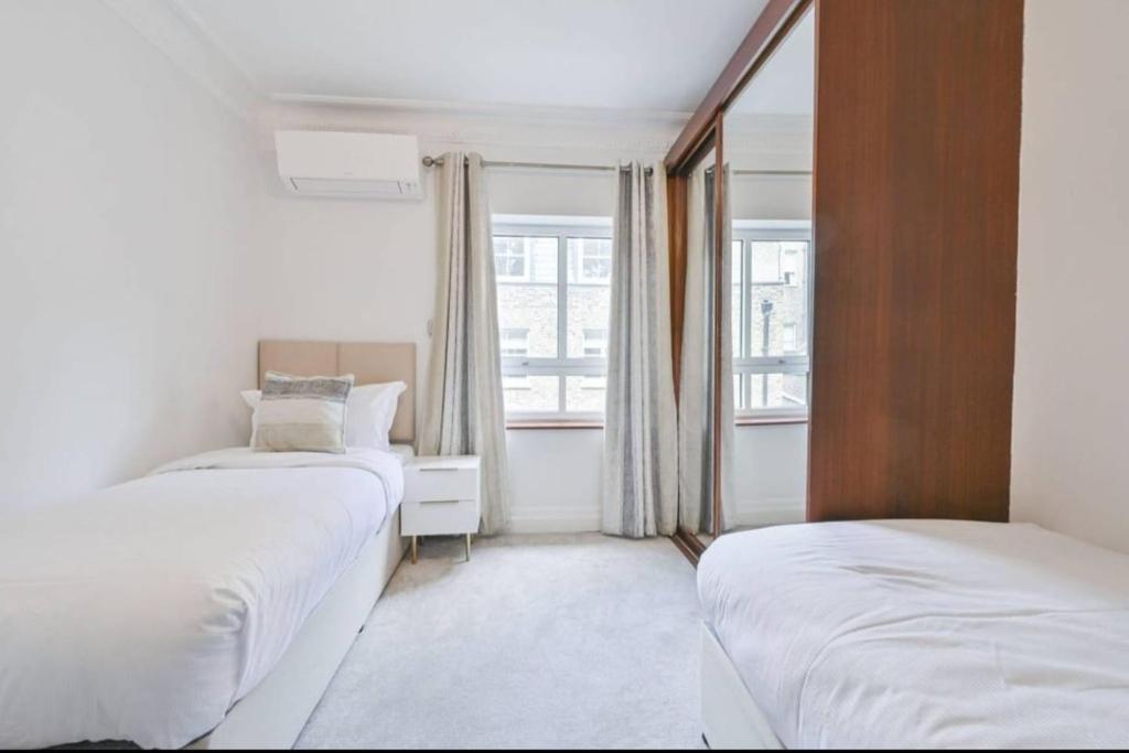 Postel nebo postele na pokoji v ubytování CARLTON COURT - MAYFAIR