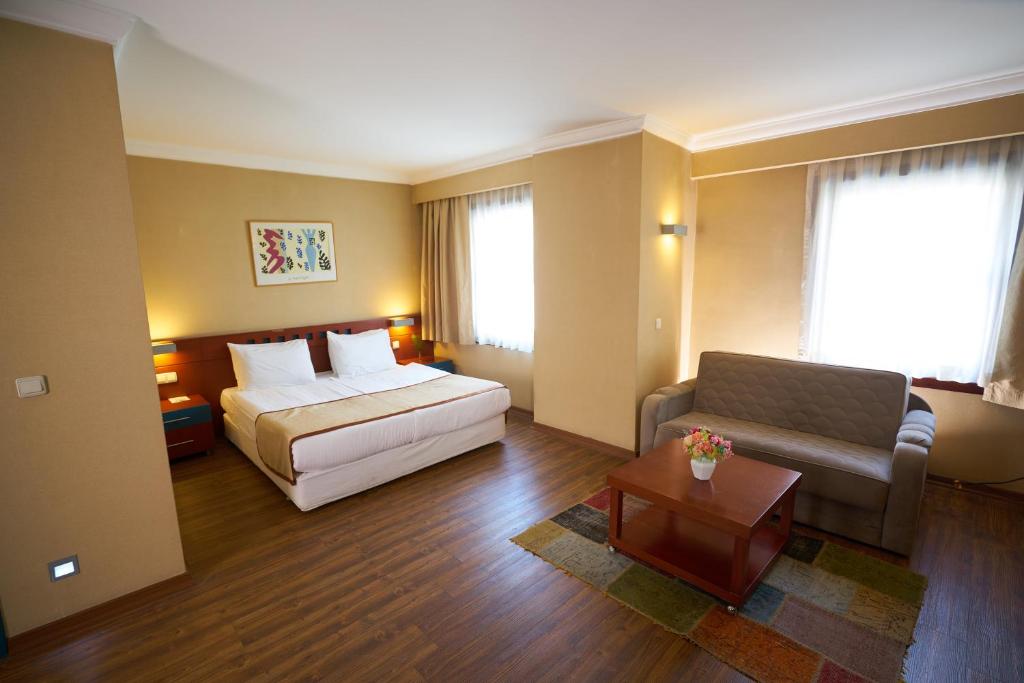 a hotel room with a bed and a couch at Feronya Hotel in Istanbul