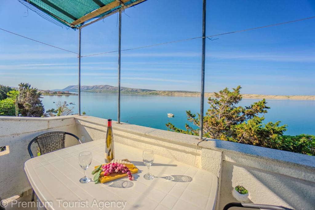 a table with two glasses and a bottle of wine at Galeb in Kustići