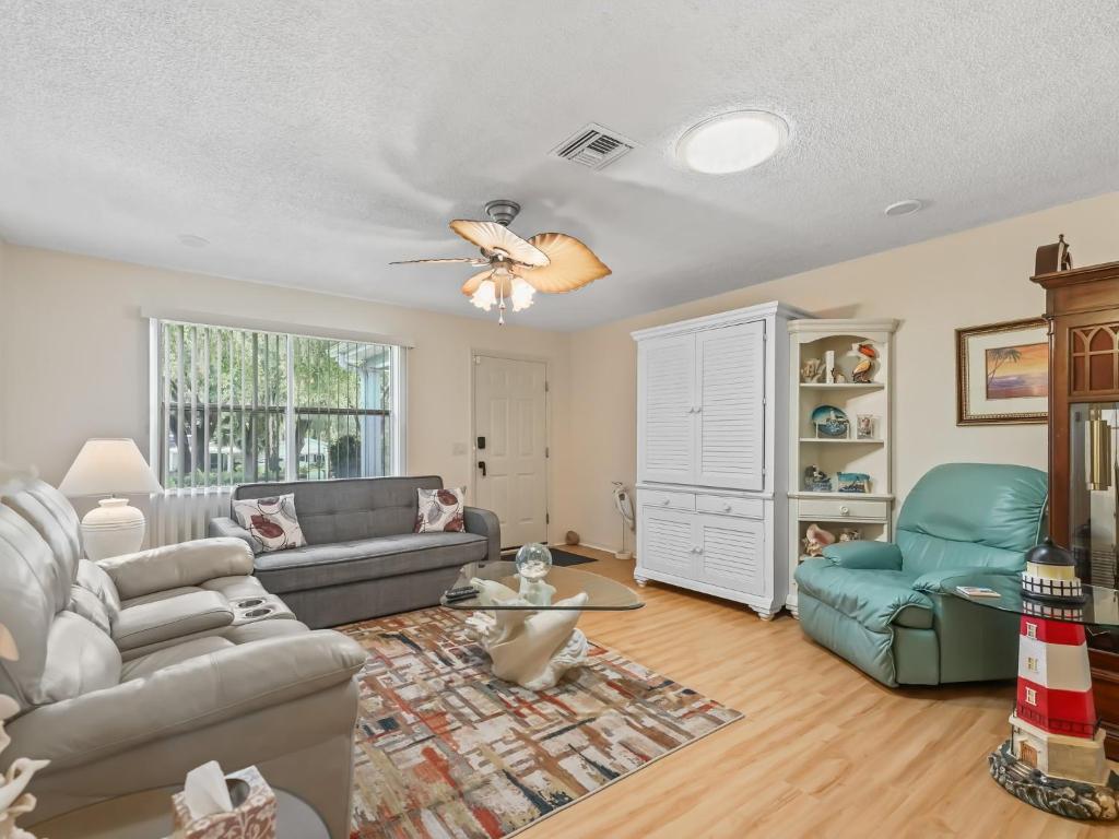 a living room with a couch and a chair at 1632 Z1 Village of Orange Blossom Gardens by REMAX Premier in The Villages
