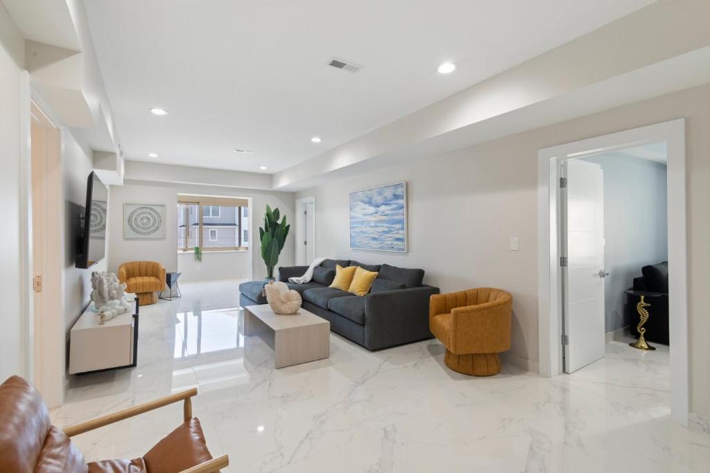 a living room with a blue couch and chairs at Ammos Luxury Living- Zakinthos Suite in Ventnor City