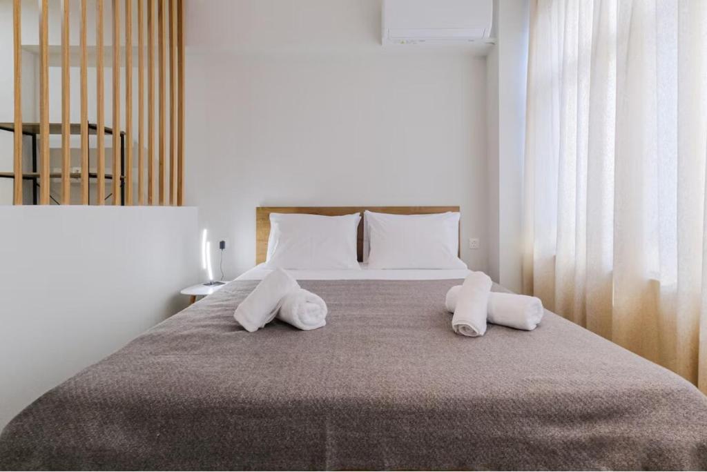 a bedroom with a large bed with two pillows at Ladadika Vibes Studio 1 in Thessaloniki