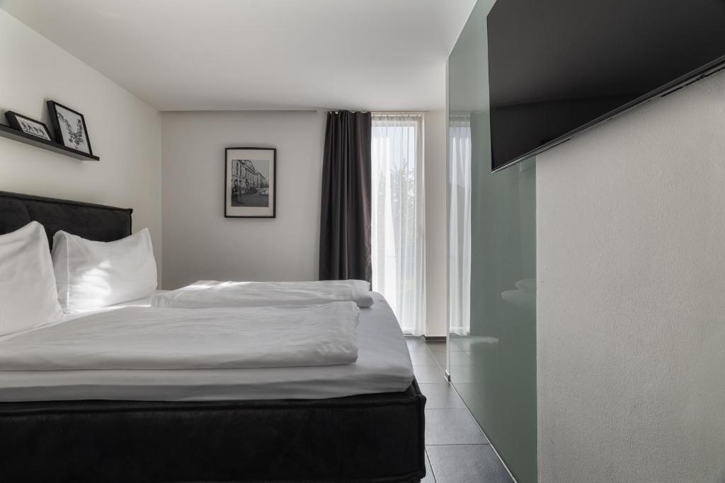 Postel nebo postele na pokoji v ubytování Motel by Maier Feldkirch - kontaktloser Check-in