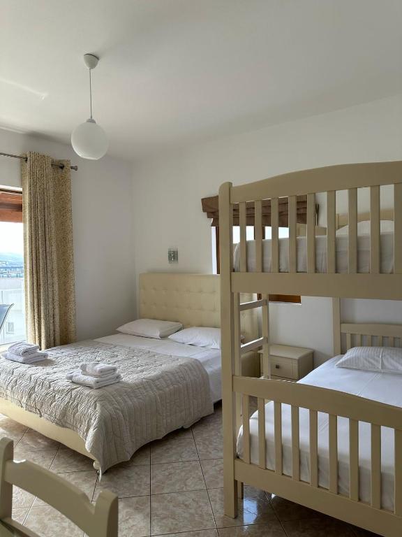 a bedroom with two bunk beds and a window at Hotel Marku in Ksamil