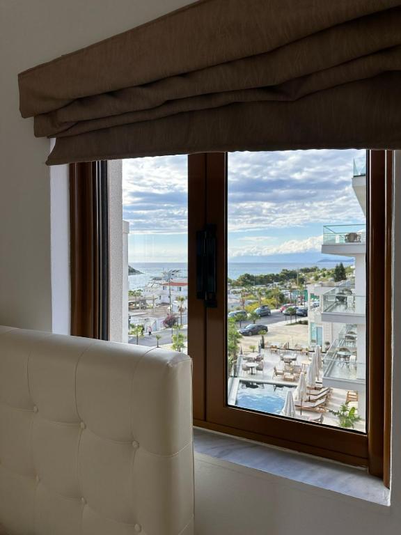 a white couch in front of a large window at Hotel Marku in Ksamil