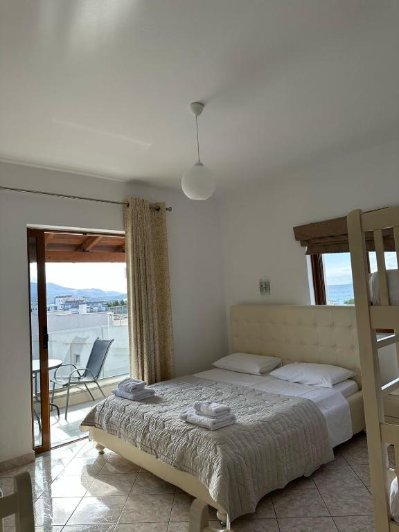 a bedroom with a bed and a view of the ocean at Hotel Marku in Ksamil