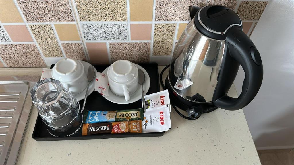 a tray with coffee and tea on a kitchen counter at Hotel Marku in Ksamil