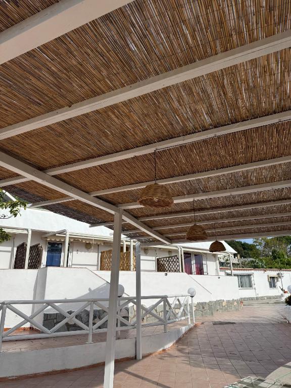 a patio umbrella with a table and chairs under it at Villa Antonio in Forio d'Ischia