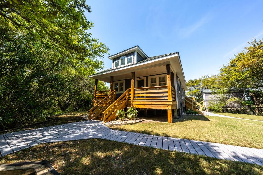 a house with a staircase leading to the front yard at Watermen's Hideout - Waterfront 2-Bed, 1-Bath Cottage with HOT TUB & Private Dog Run! in Waves