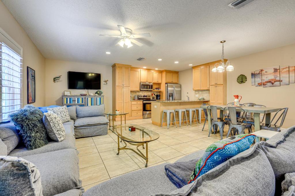 a living room with a couch and a table at St Augustine Island Cottage - Walk to Beach in Saint Augustine