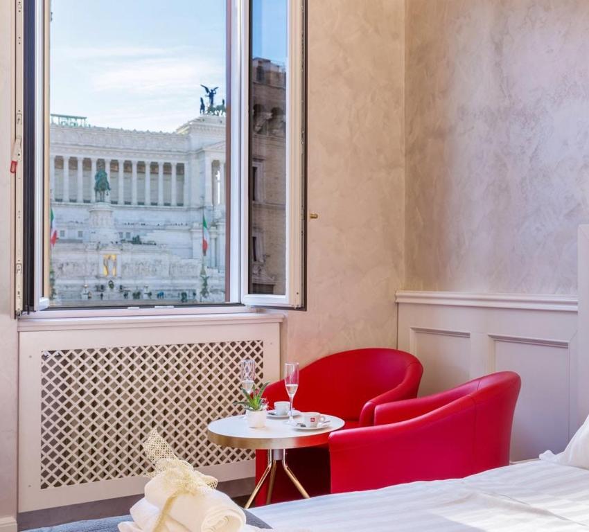 a room with a table and two chairs and a window at Piazza Venezia appartamento con vista in Rome