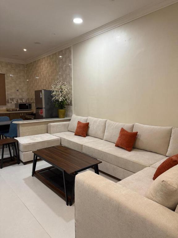 a living room with a couch and a table at hajer221 in Al Hofuf