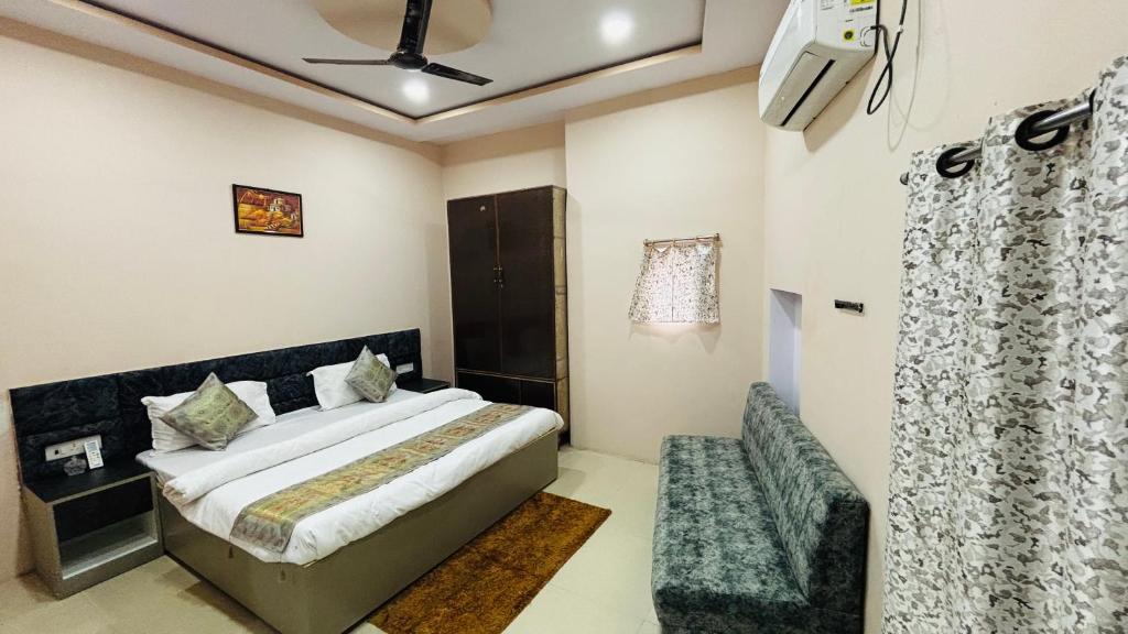 a hotel room with a bed and a chair at Spiritual Homestay in Varanasi
