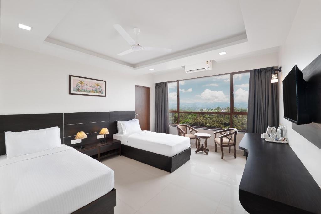 Postel nebo postele na pokoji v ubytování BSG Porvorim Regency Hotel Goa