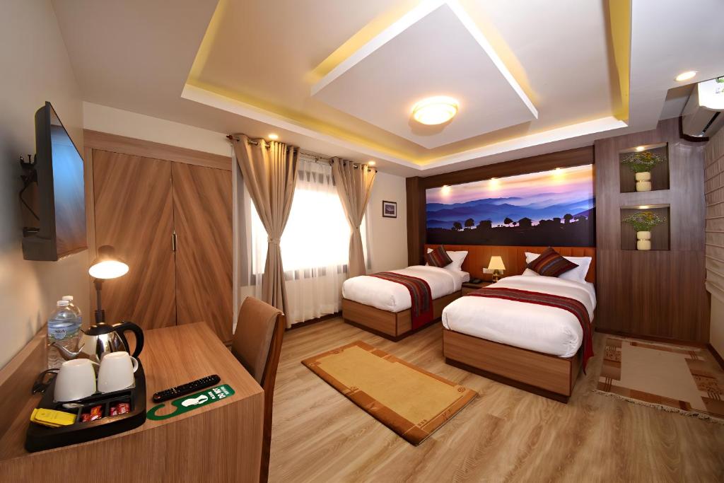 Postel nebo postele na pokoji v ubytování Hotel Sherpani