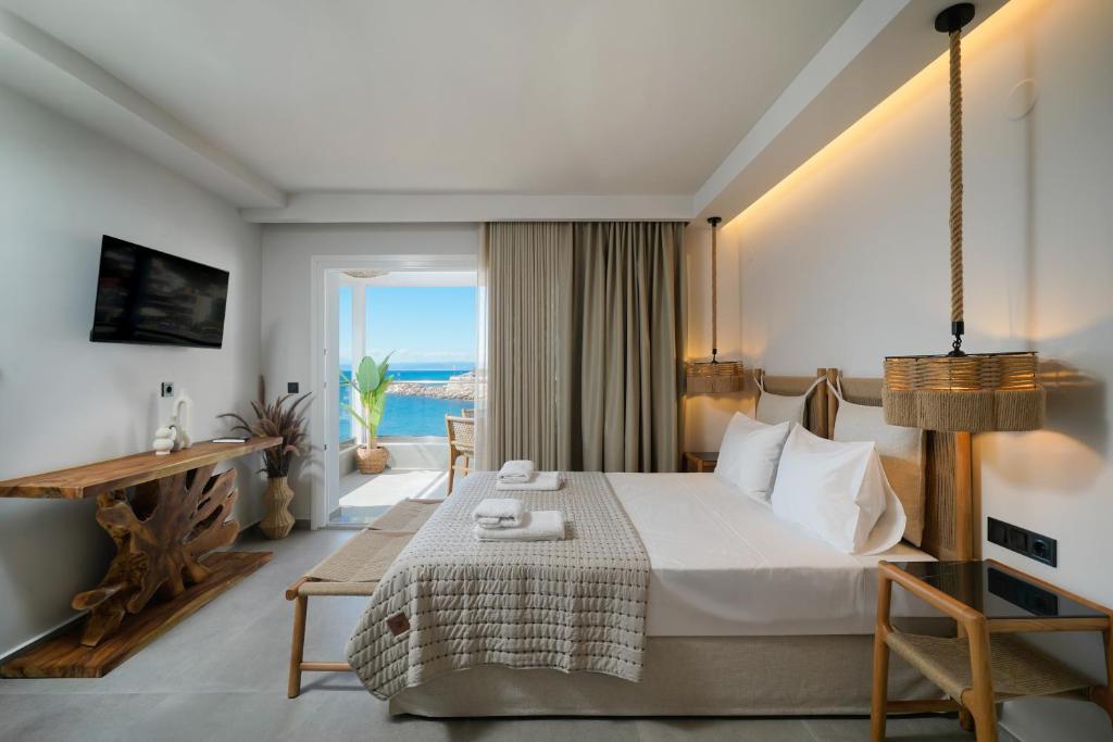 A bed or beds in a room at Apollonia by Stone Village