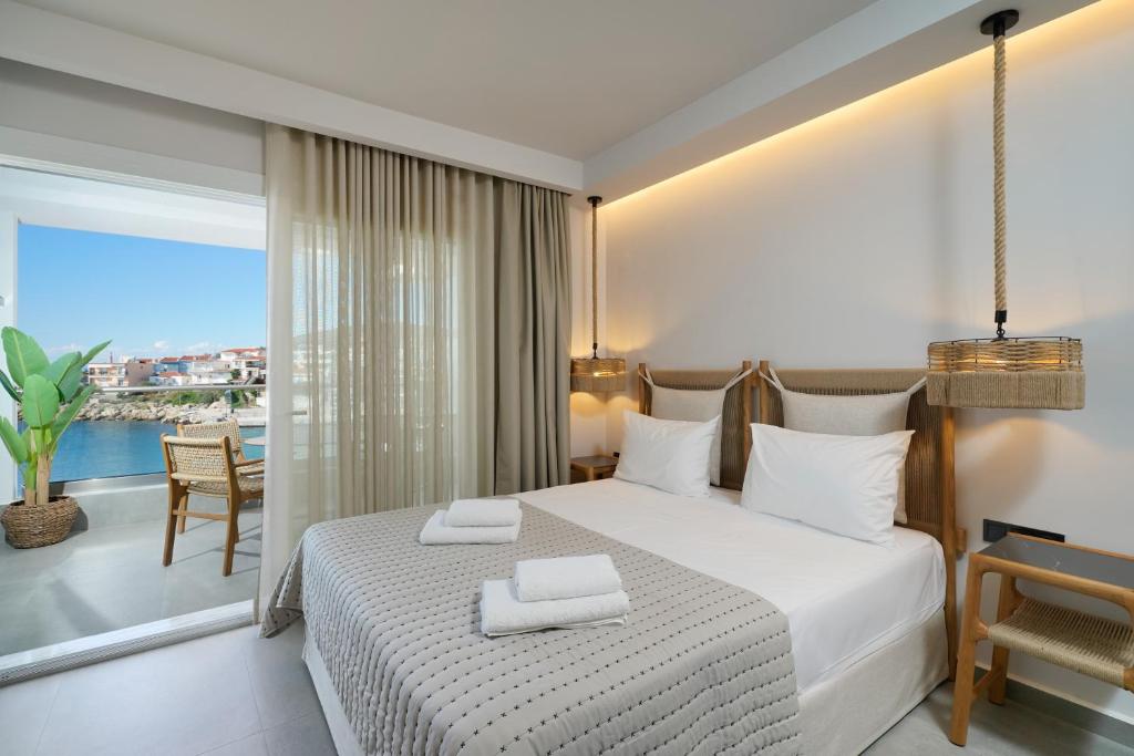 A bed or beds in a room at Apollonia by Stone Village