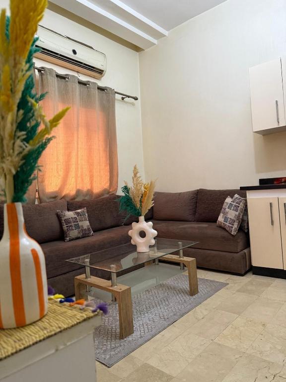 a living room with a couch and a table at Modern studio near the center in Marrakech