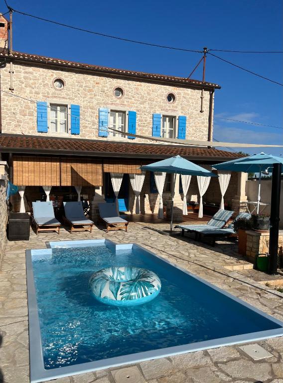 a swimming pool with a fish in the water at Villa Rafaela Umag in Umag
