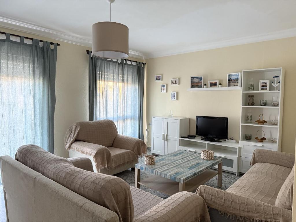 a living room with two couches and a tv at Magnífico piso céntrico in Isla Cristina