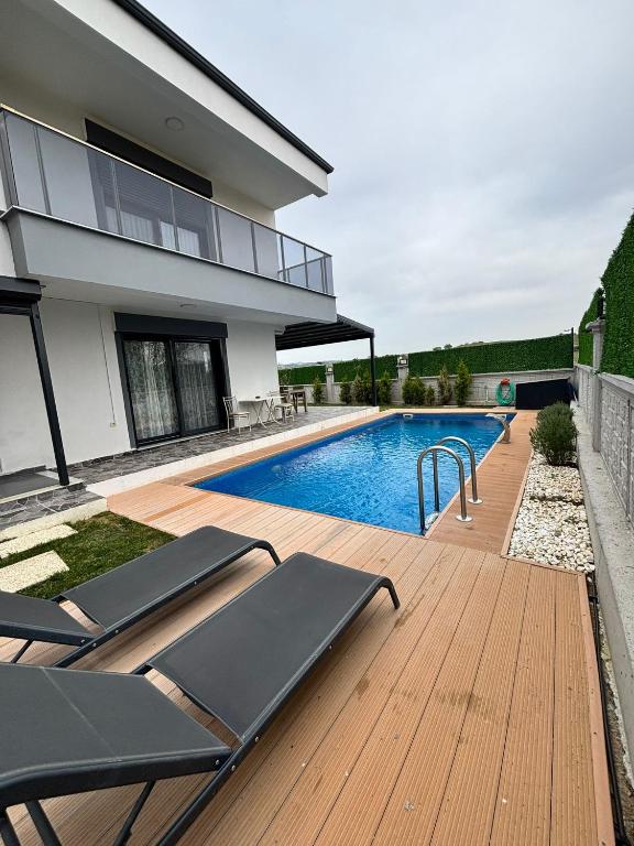 a house with a swimming pool next to a house at Villa Keyif in Seferihisar