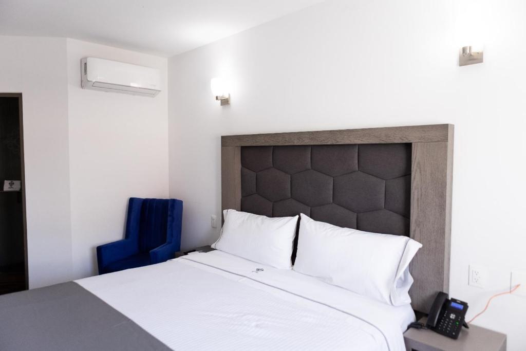 Postel nebo postele na pokoji v ubytování Hotel Bugari Aeropuerto Guadalajara