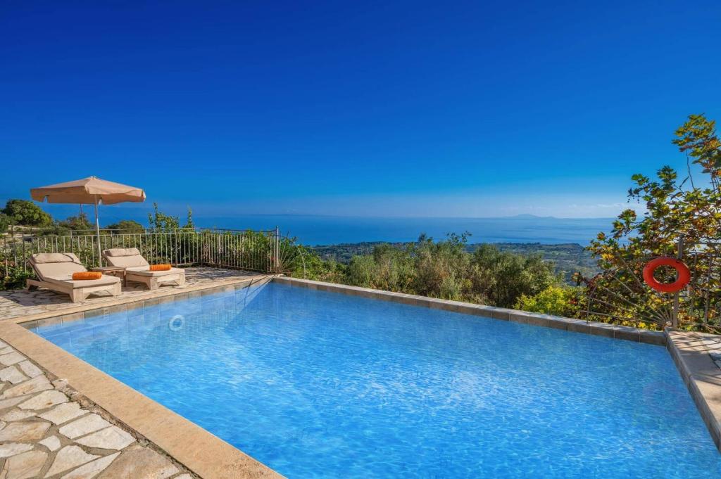 a swimming pool with a view of the ocean at Villa Ifandis by Villa Plus in Ratzaklíon