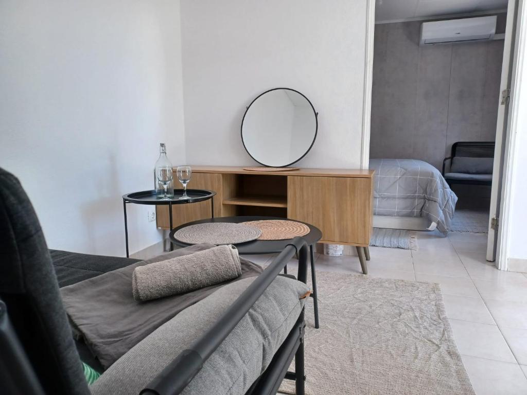 a living room with a mirror on a table at Casa de Férias Palmeira in Faro