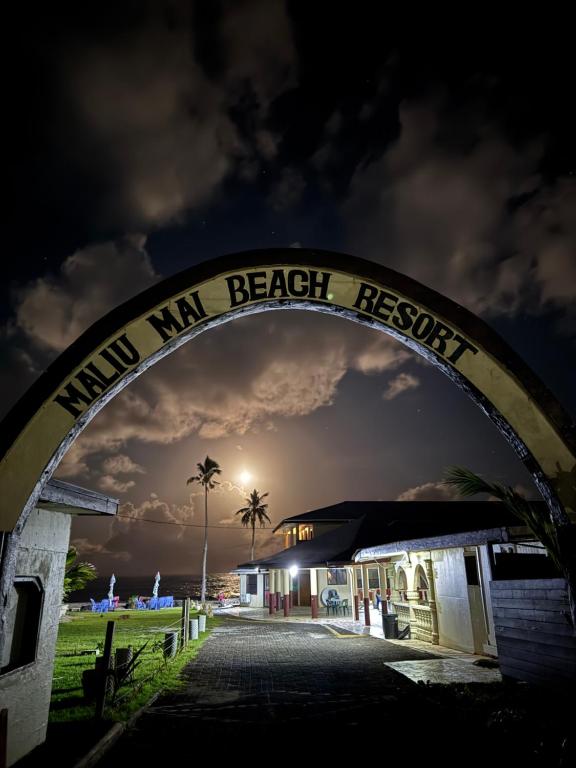 a archway leading to a beach resort at night at Maliu Mai Beach Resort in Tafuna